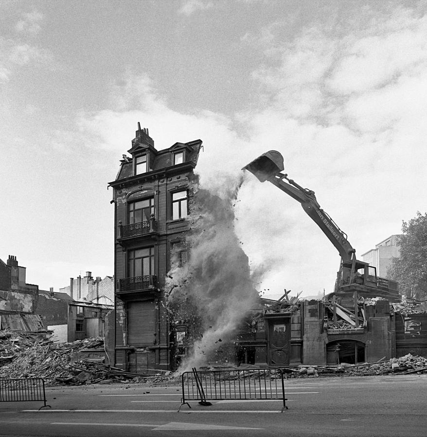 Photo of a digger destroying a house<br>	