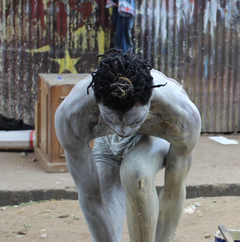 Image of a person with body painting doing a performance<br>	